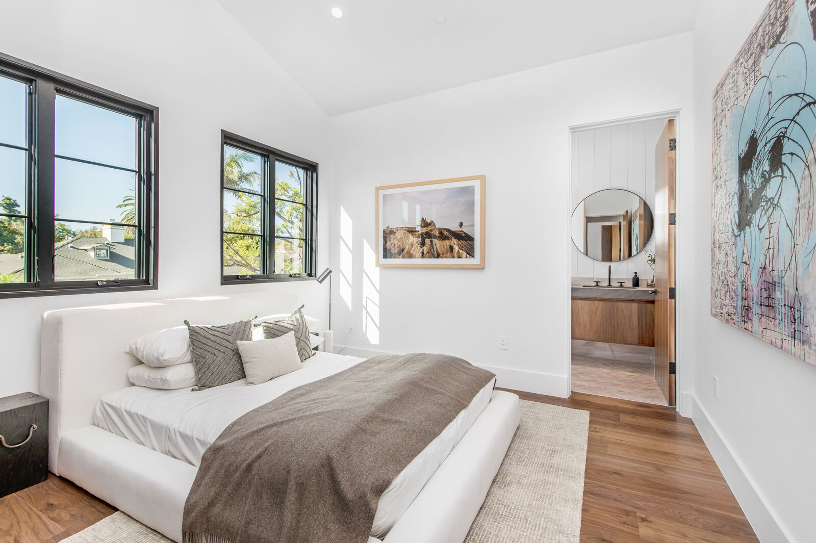 Bright Van Nuys bedroom with black-framed windows and ensuite view