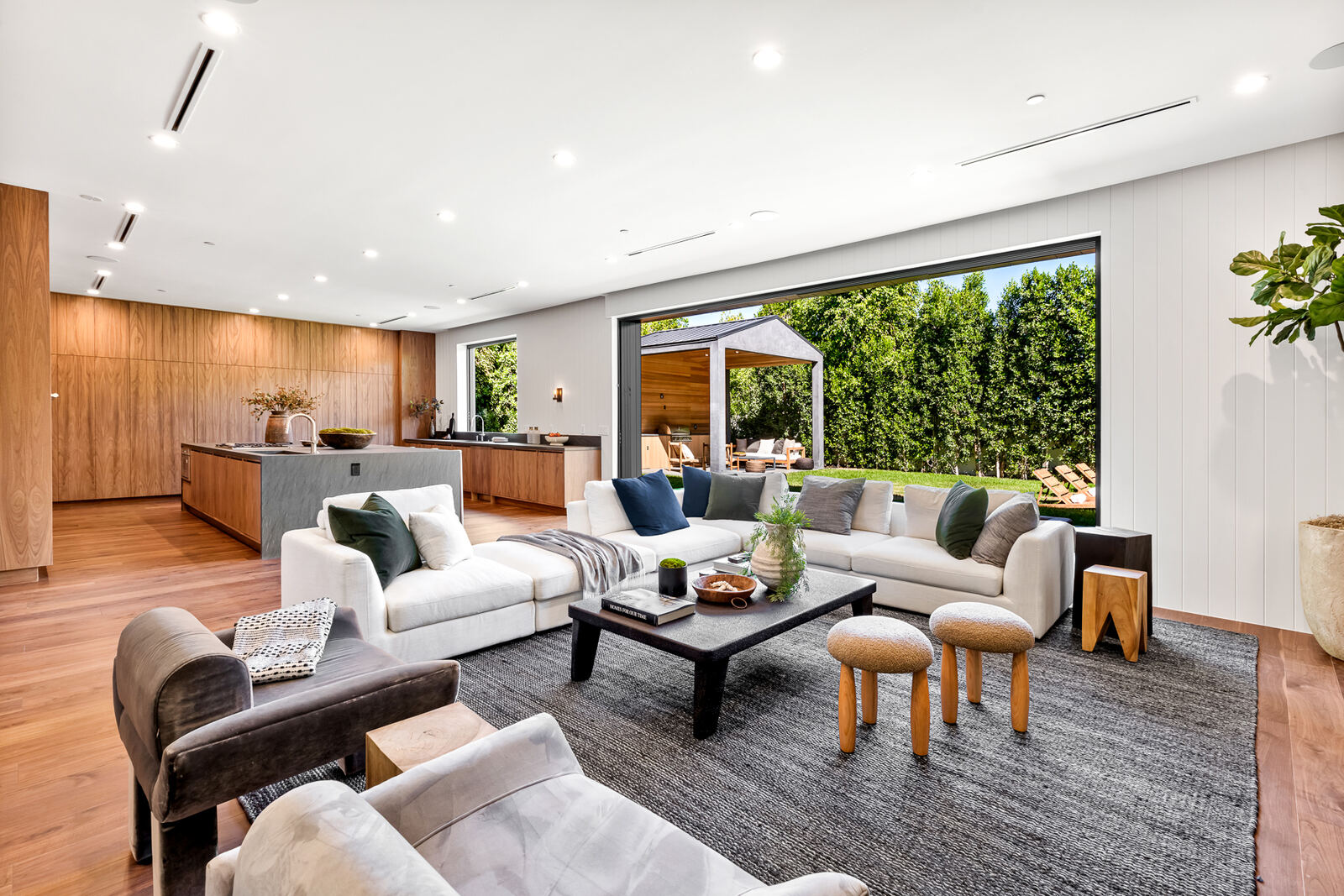 Van Nuys living room opening to a covered backyard patio