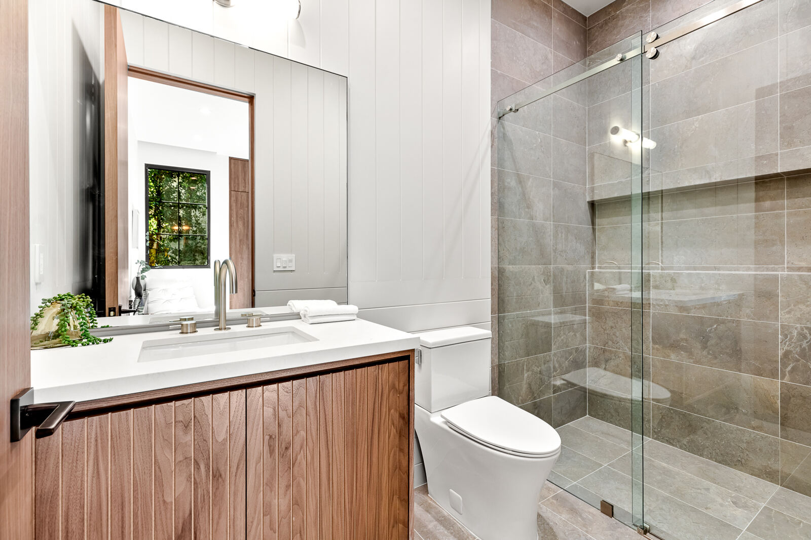 Small San Fernando Valley bathroom with wood vanity and glass shower